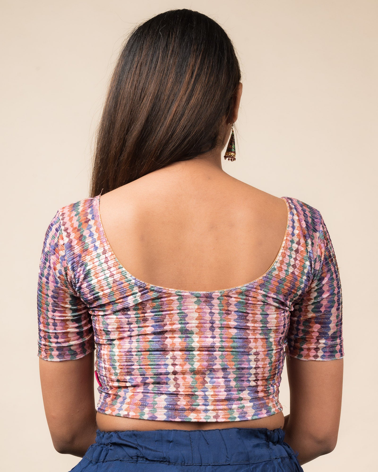 Rear view of the velvet stretchable blouse showcasing the back design and abstract pattern.