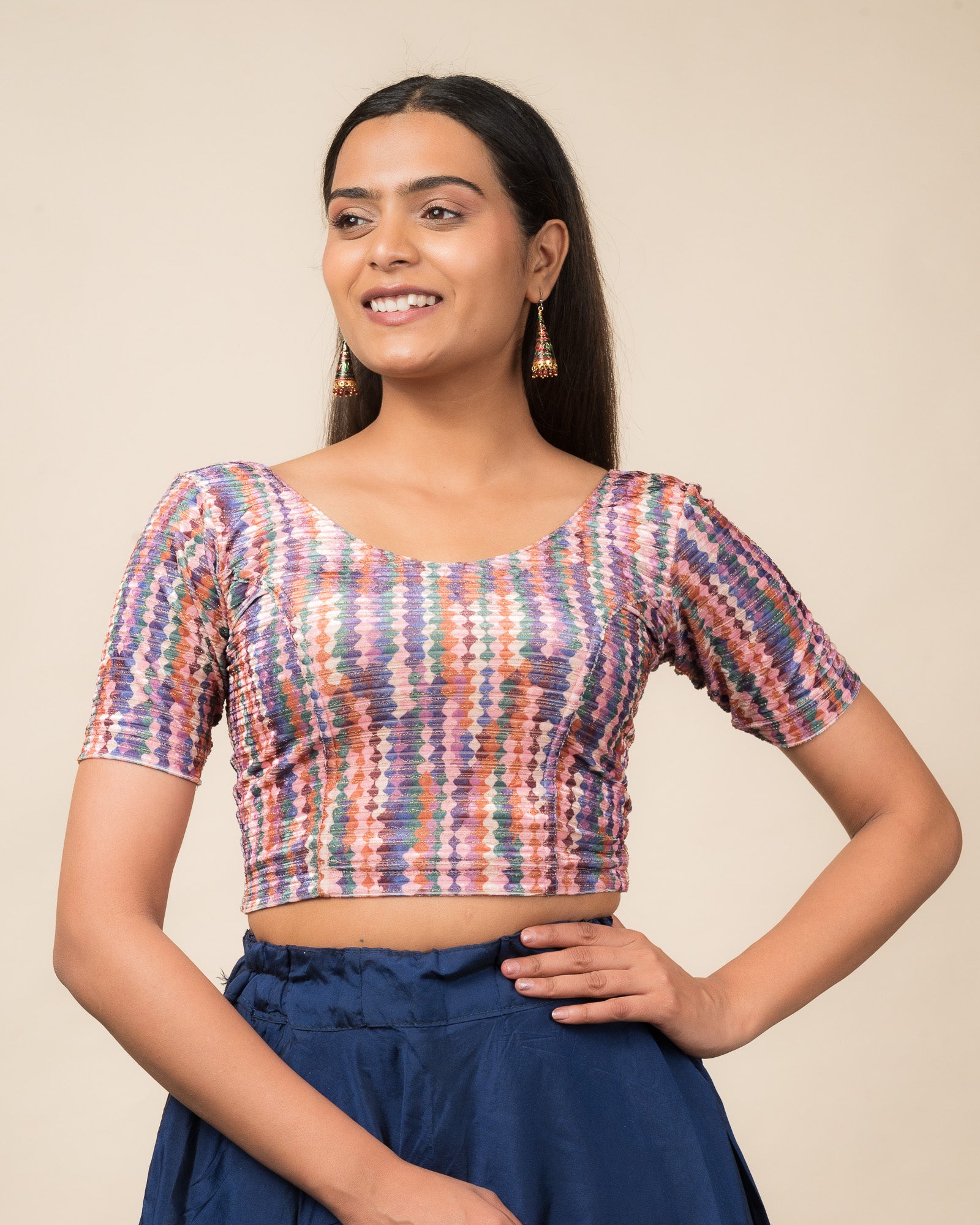 Model wearing a velvet stretchable readymade blouse with elbow sleeves and round neckline featuring modern abstract print.