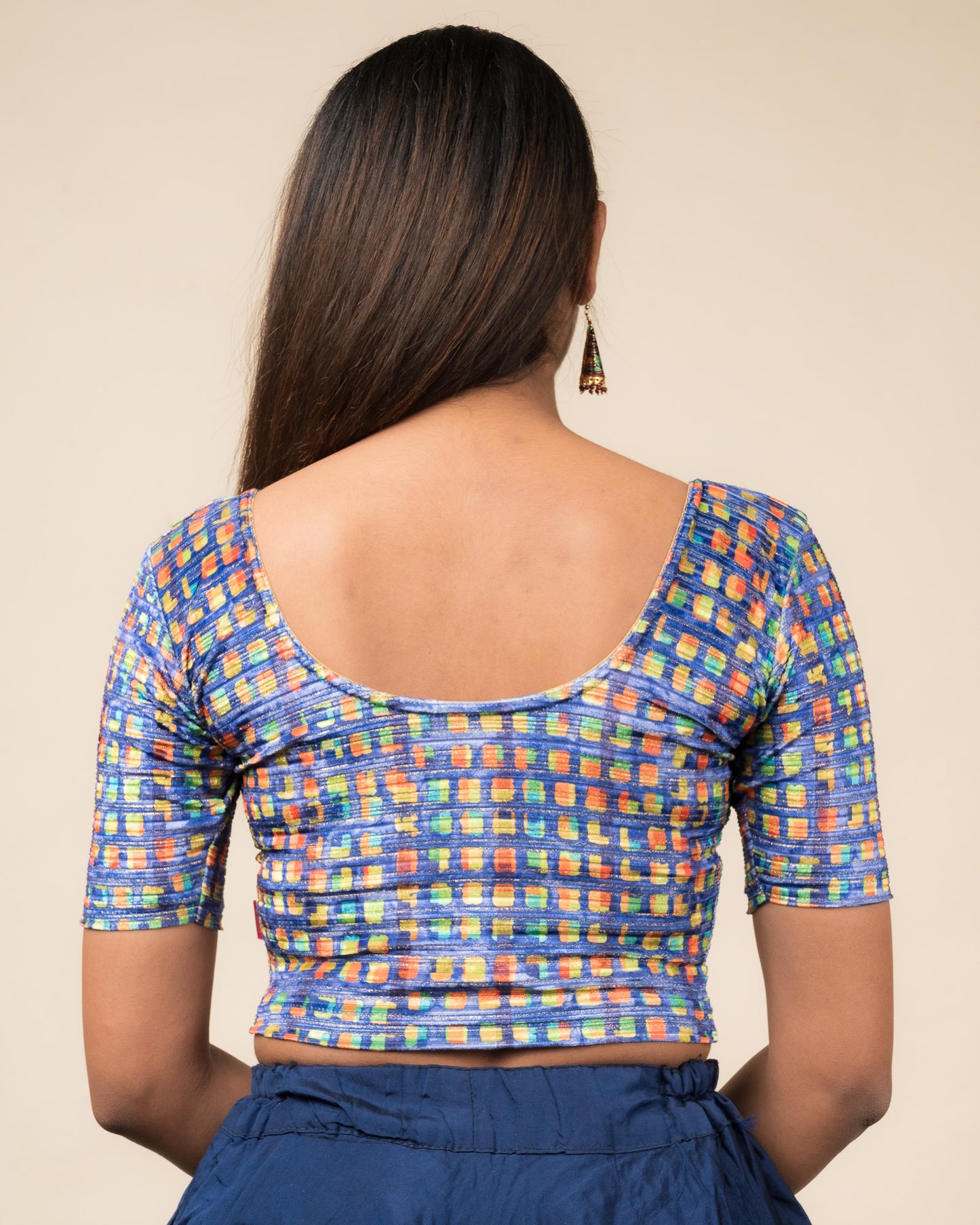 Rear view of the velvet stretchable blouse showcasing the back design and abstract pattern.
