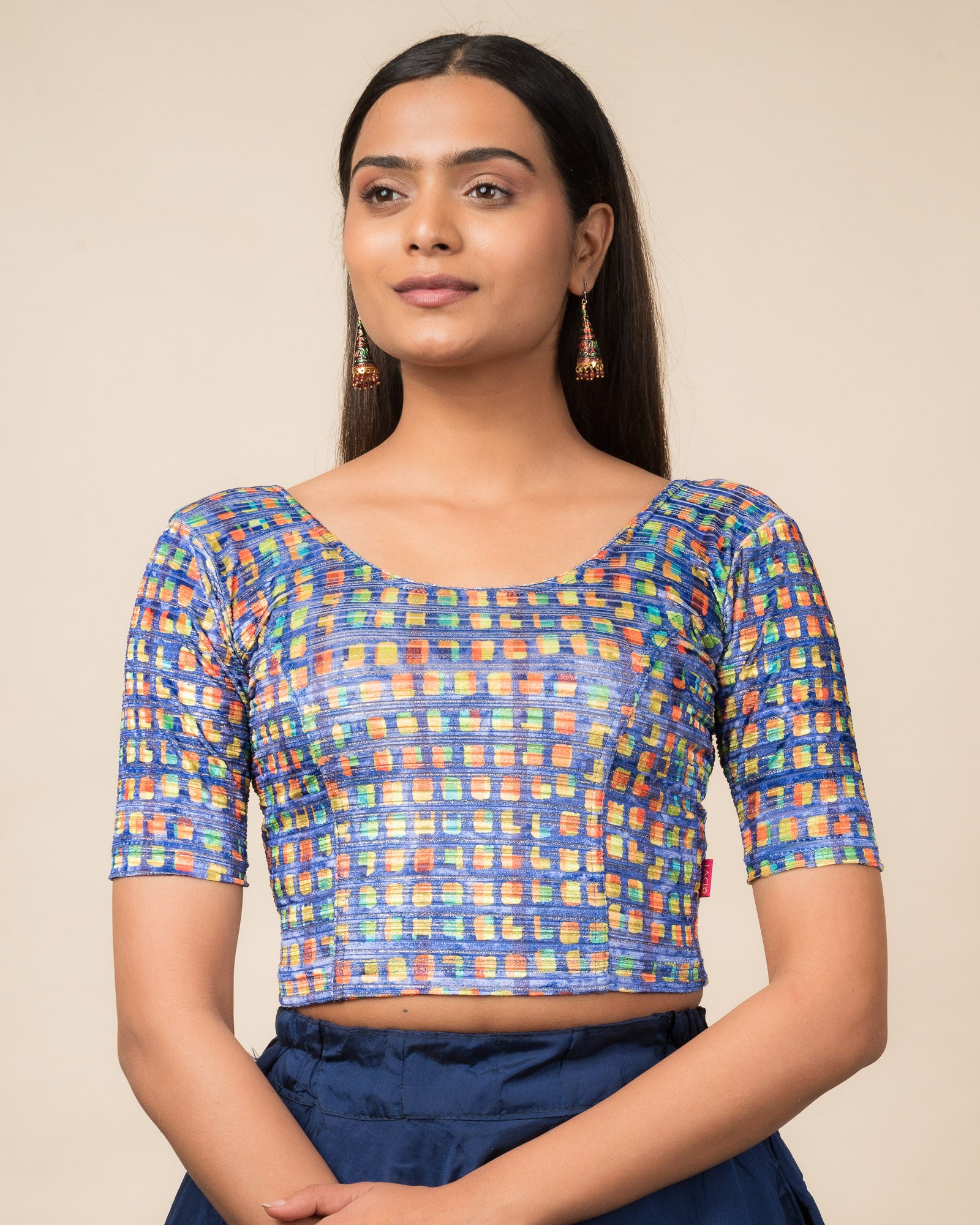 Model wearing a velvet stretchable readymade blouse with elbow sleeves and round neckline featuring modern abstract print.