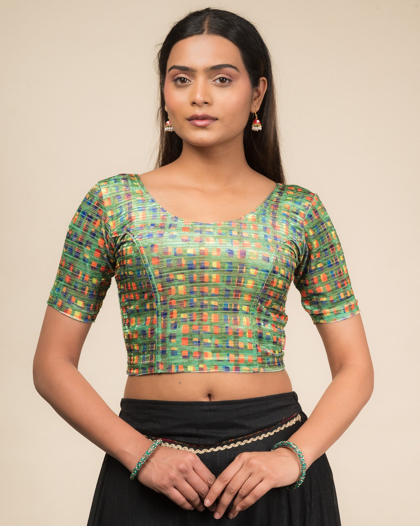 Model wearing a velvet stretchable readymade blouse with elbow sleeves and round neckline featuring modern abstract print.