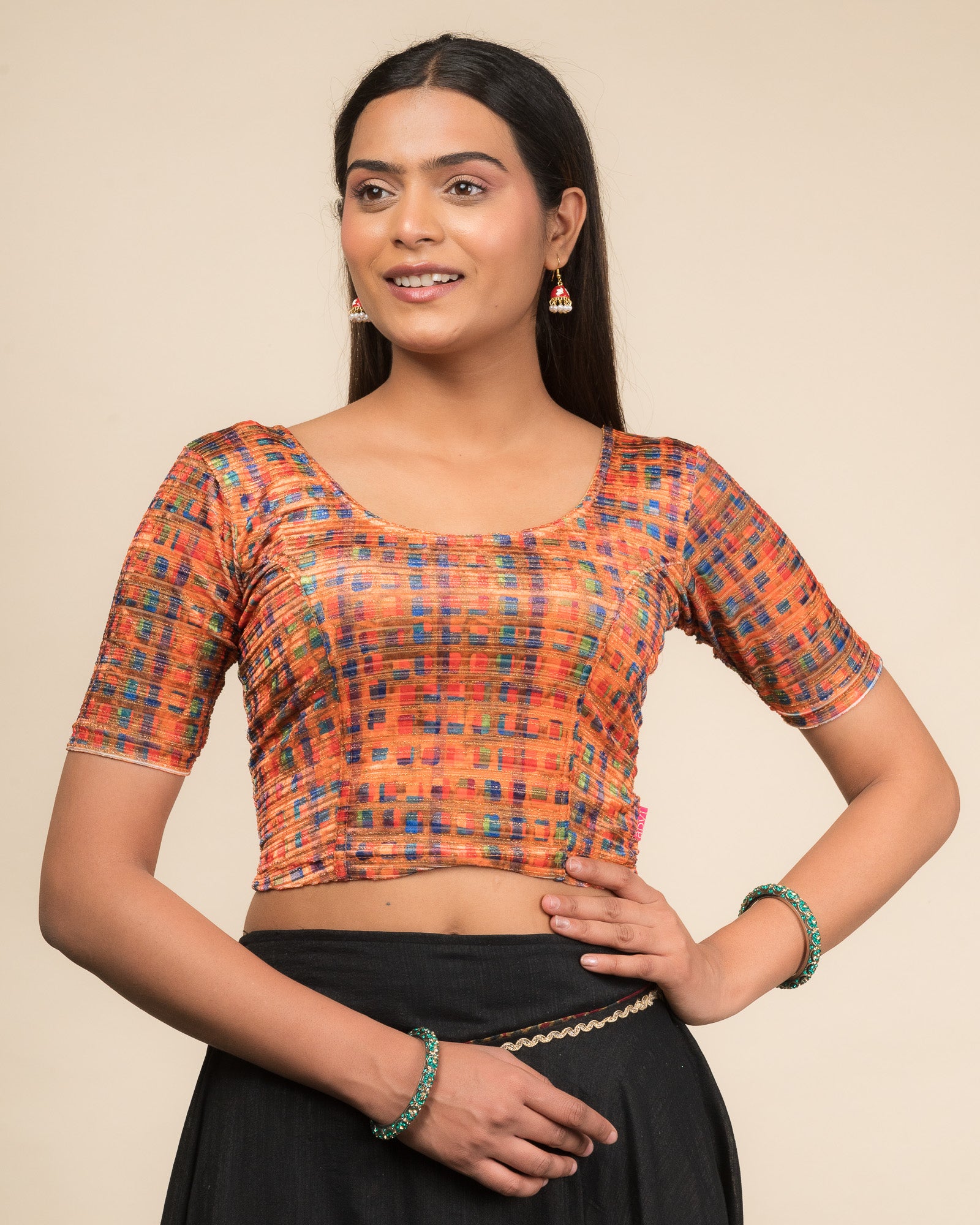 Model wearing a velvet stretchable readymade blouse with elbow sleeves and round neckline featuring modern abstract print.