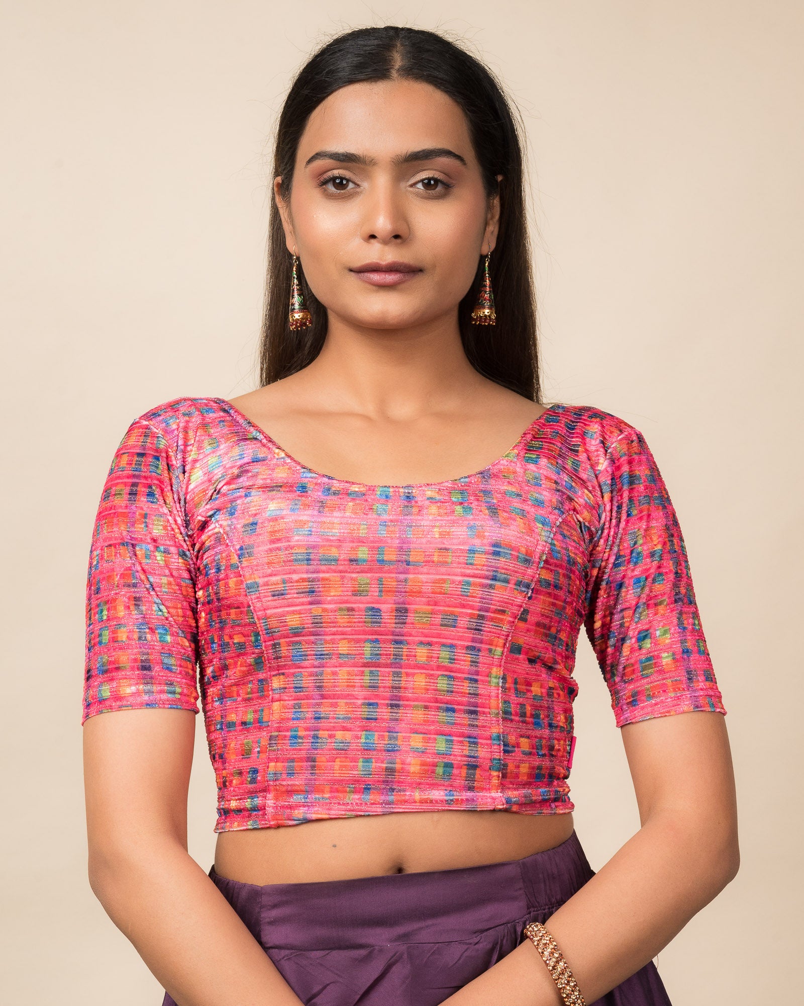 Model wearing a velvet stretchable readymade blouse with elbow sleeves and round neckline featuring modern abstract print.