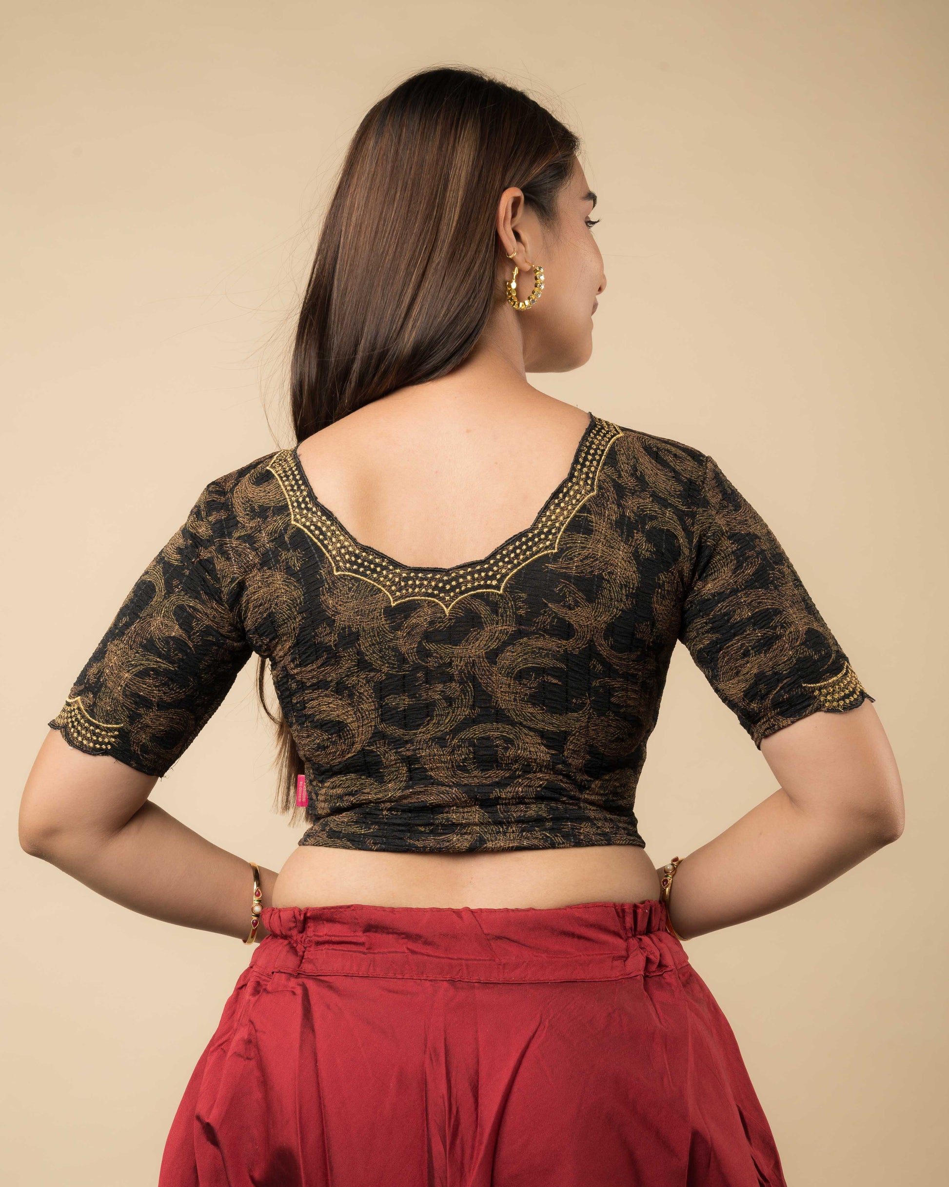 Rear view of the black-colored stretchable blouse showcasing the back design and zari embroidery.