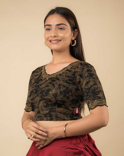 Side profile of the black-colored stretchable blouse highlighting the fit, sleeve length, and zari embroidery.