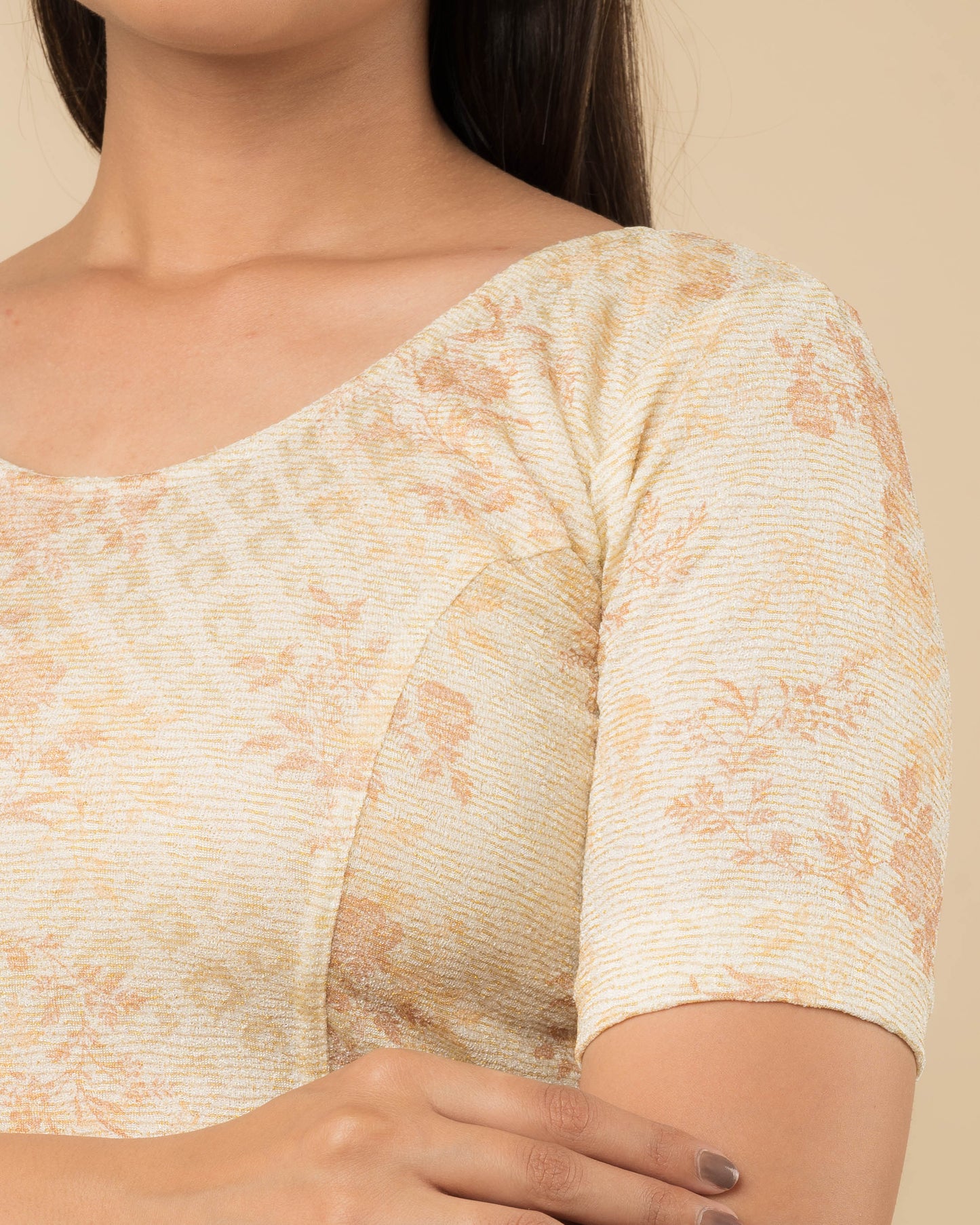 Close-up of the jacquard fabric detailing the metallic floral pattern and stretchability of the readymade blouse.