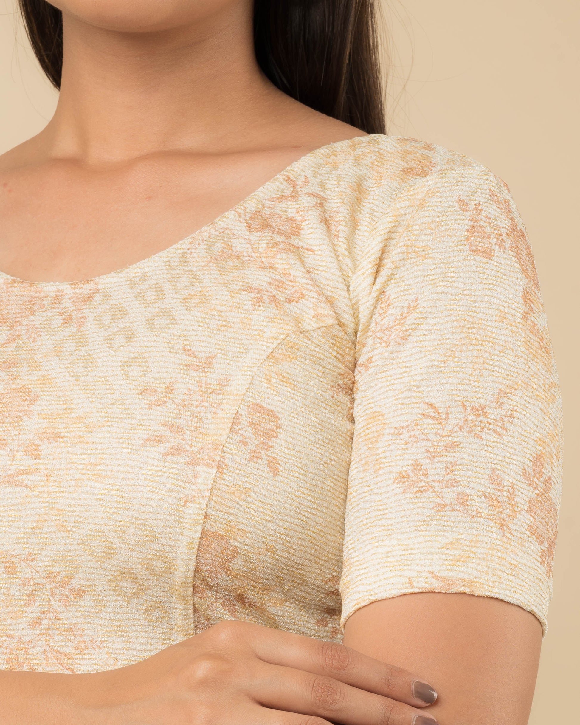 Close-up of the jacquard fabric detailing the metallic floral pattern and stretchability of the readymade blouse.