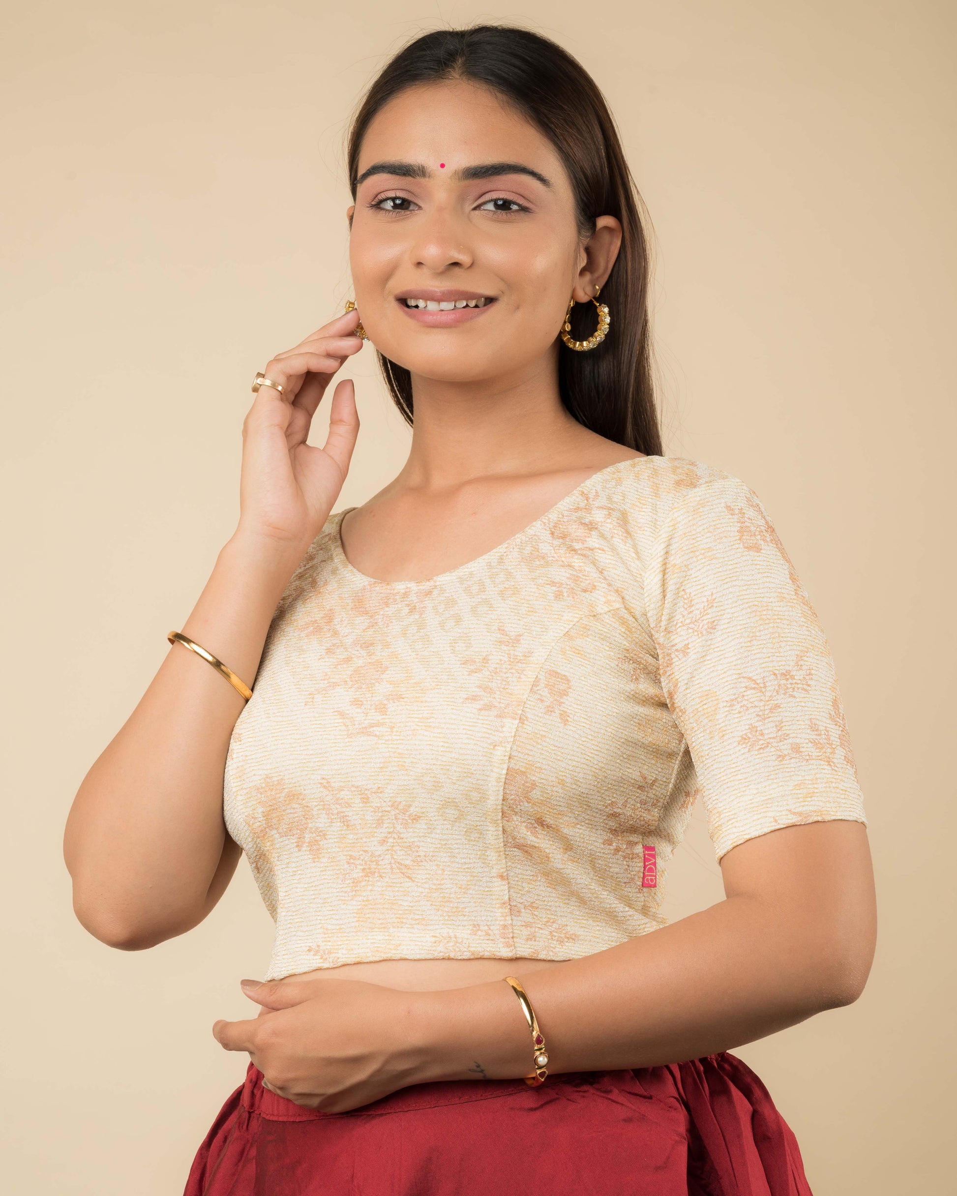 Side profile of the metallic floral stretchable blouse highlighting the fit and sleeve length.
