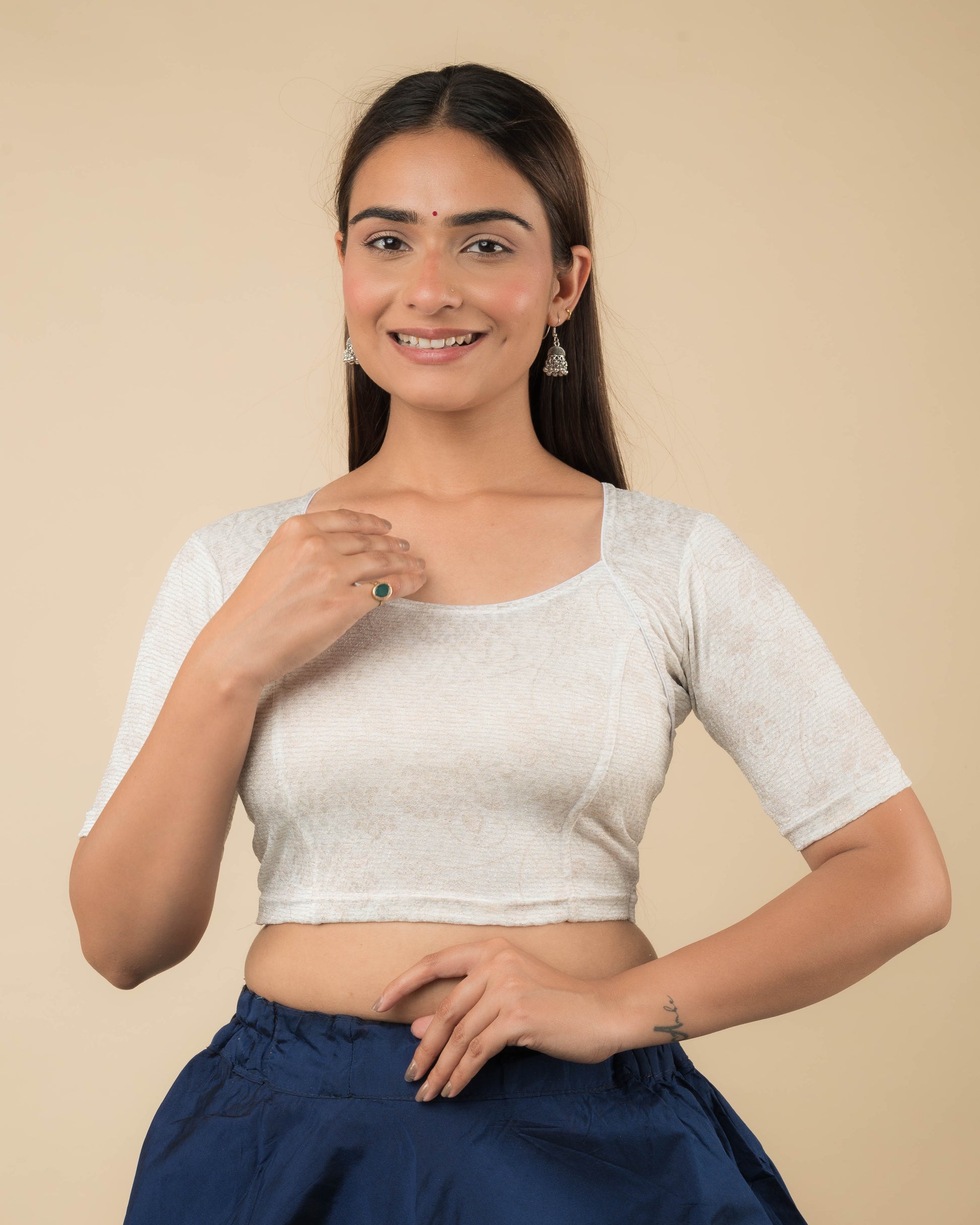 Model wearing a metallic floral stretchable readymade blouse with elbow sleeves and sweetheart neckline.