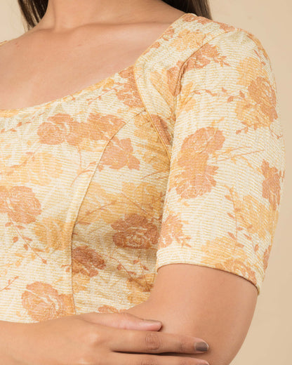 Close-up of the jacquard fabric detailing the metallic floral pattern and stretchability of the readymade blouse.