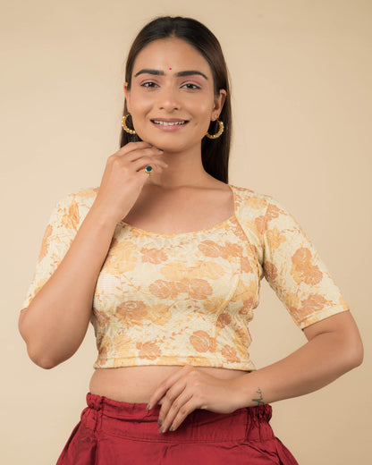  Model wearing a metallic floral stretchable readymade blouse with elbow sleeves and sweetheart neckline.
