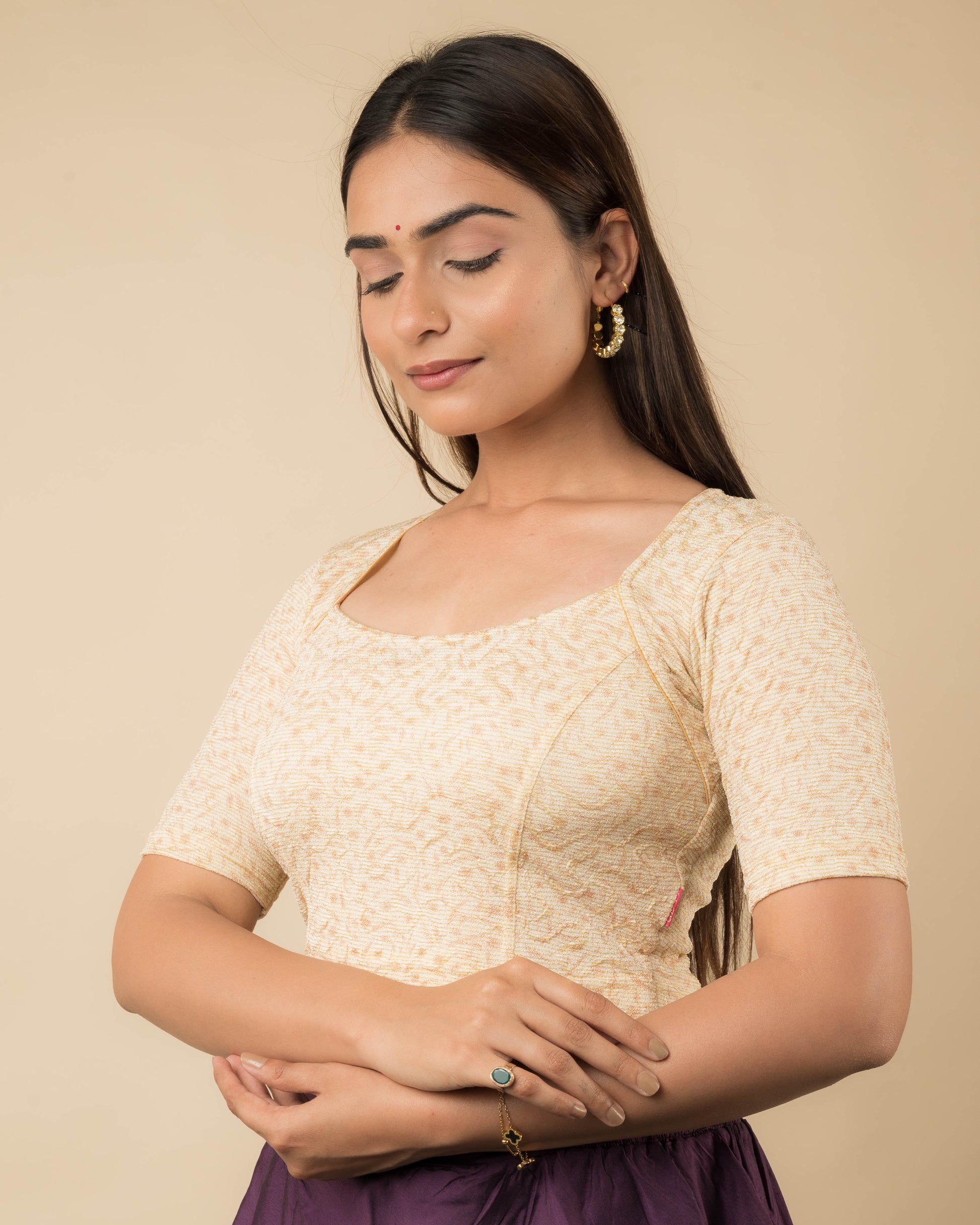 Side profile of the metallic floral stretchable blouse highlighting the fit and sleeve length.