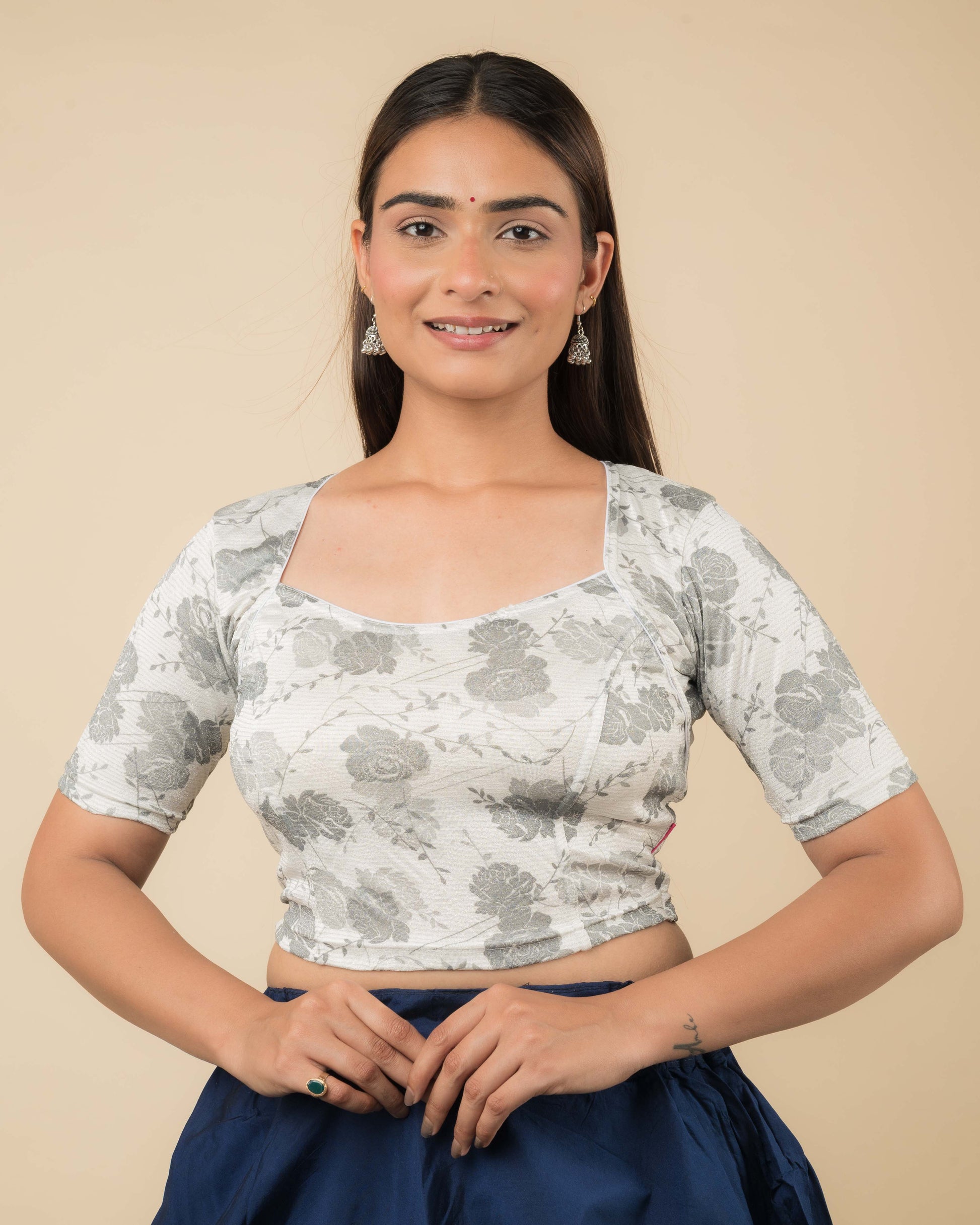 Model wearing a metallic floral stretchable readymade blouse with elbow sleeves and sweetheart neckline.
