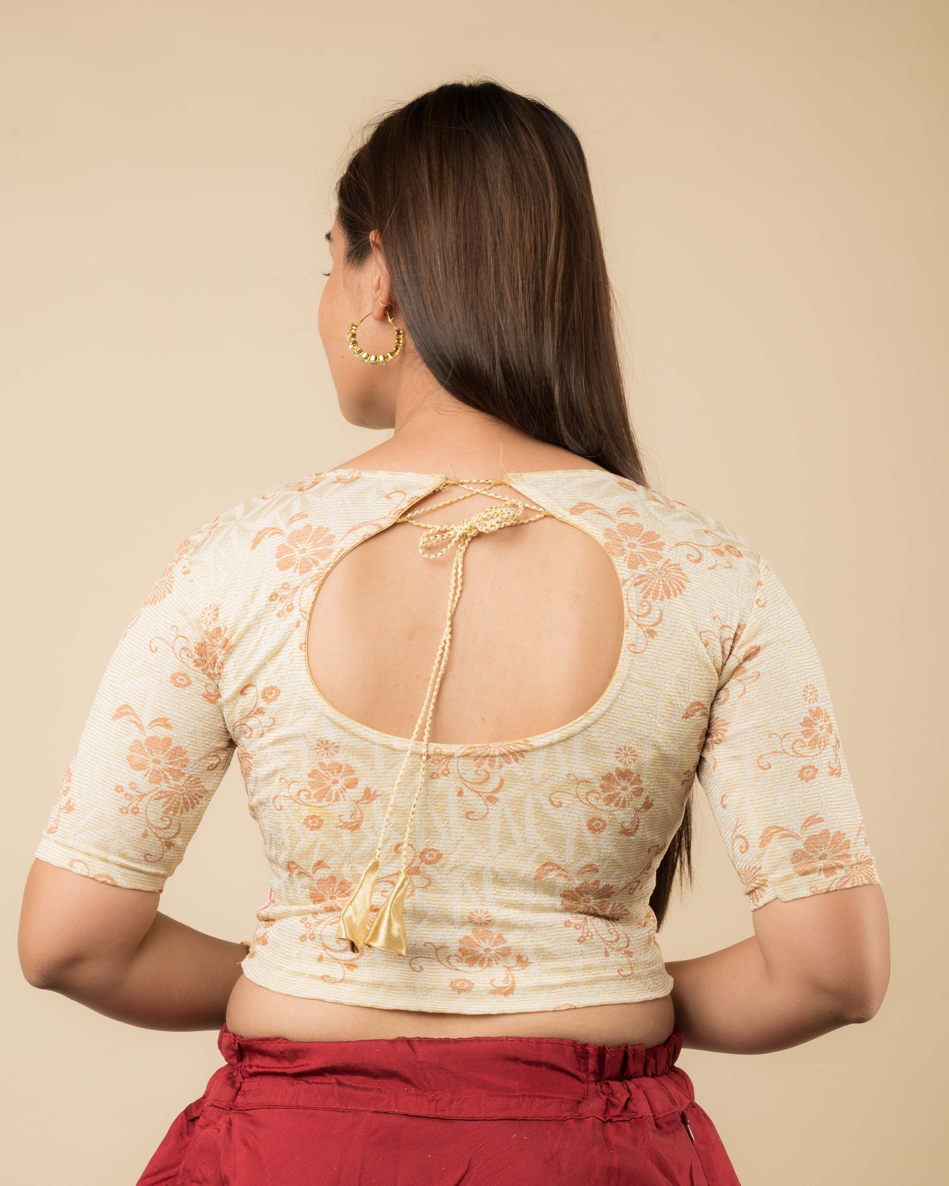 Rear view of the jacquard stretchable blouse showcasing the dori tie-up with tassels.