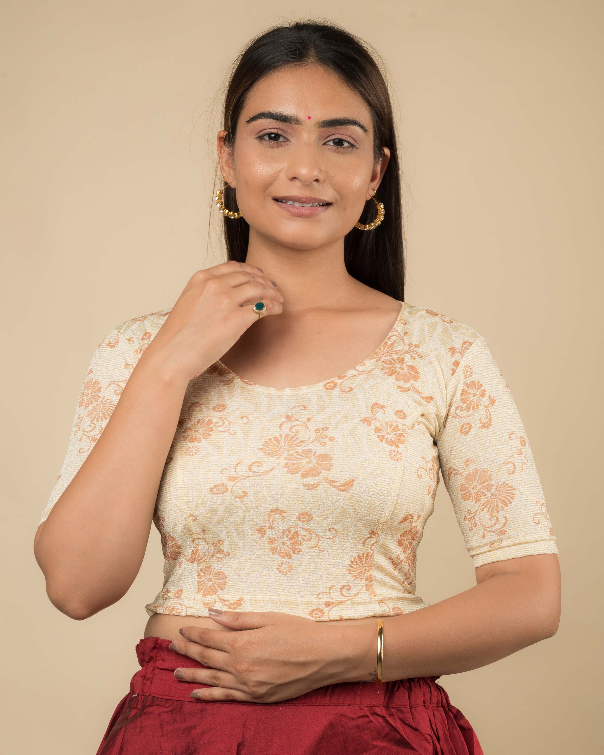 Model wearing a jacquard stretchable readymade blouse with elbow sleeves and round neckline.

