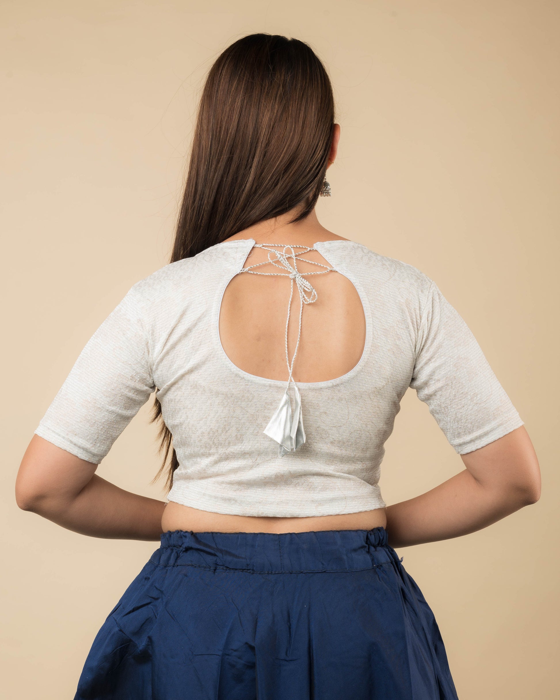 Rear view of the jacquard stretchable blouse showcasing the dori tie-up with tassels.