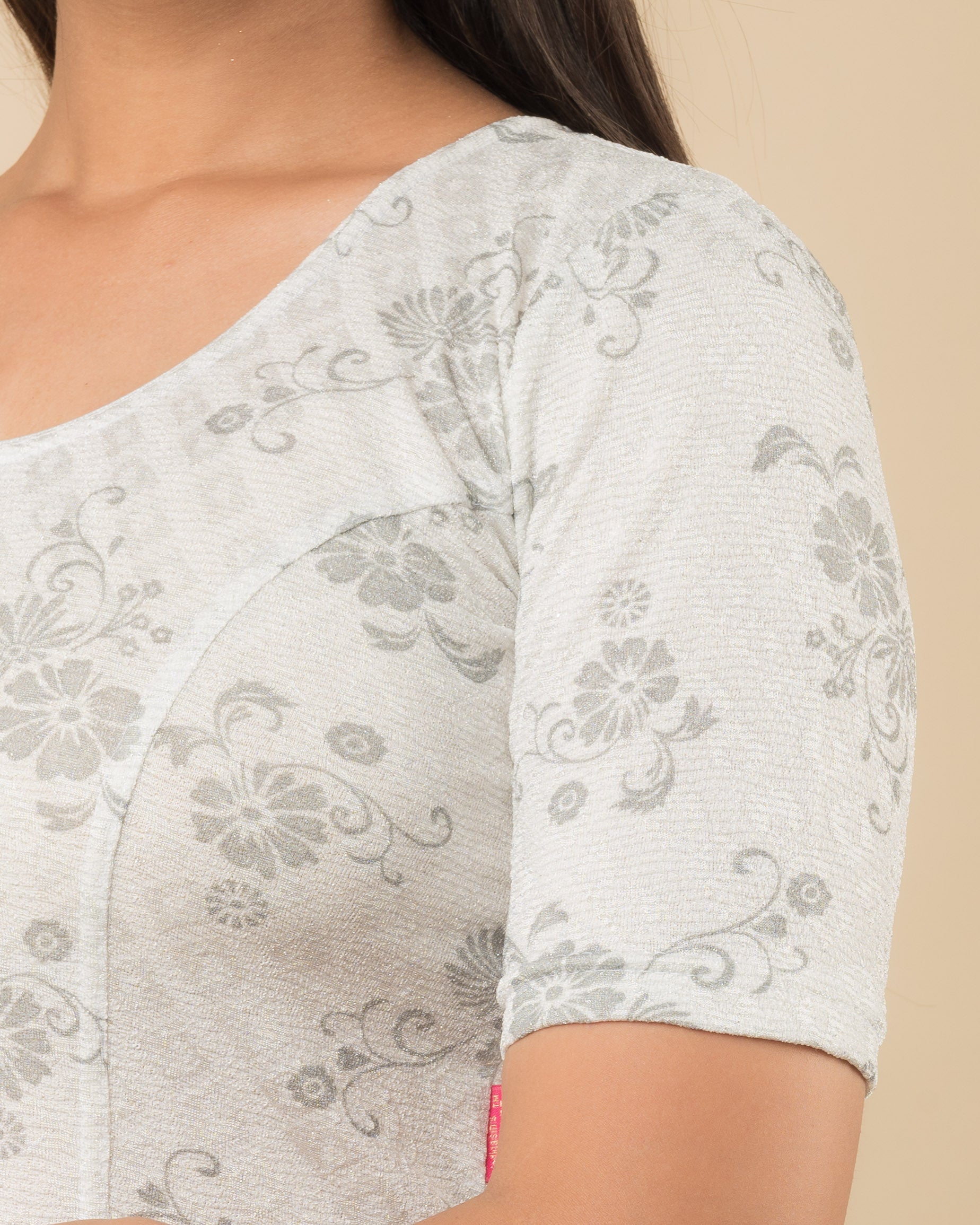 Close-up of the jacquard fabric detailing the self-design pattern and stretchability of the readymade blouse.