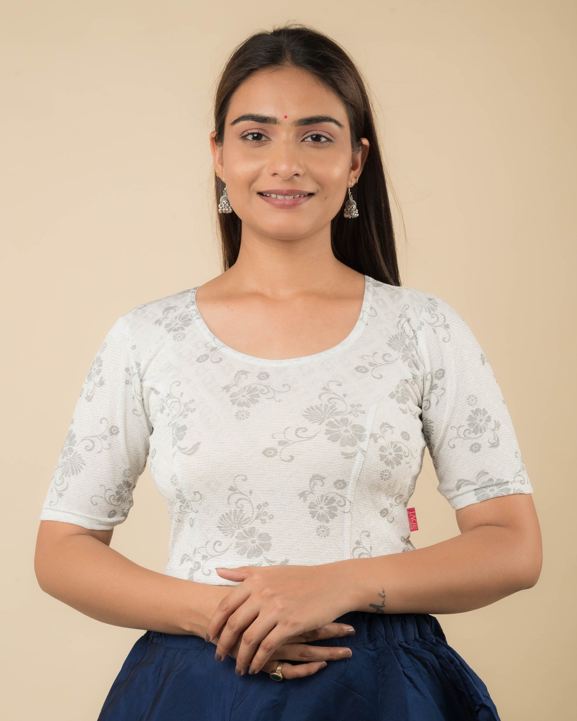  Model wearing a  jacquard stretchable readymade blouse with elbow sleeves and round neckline.