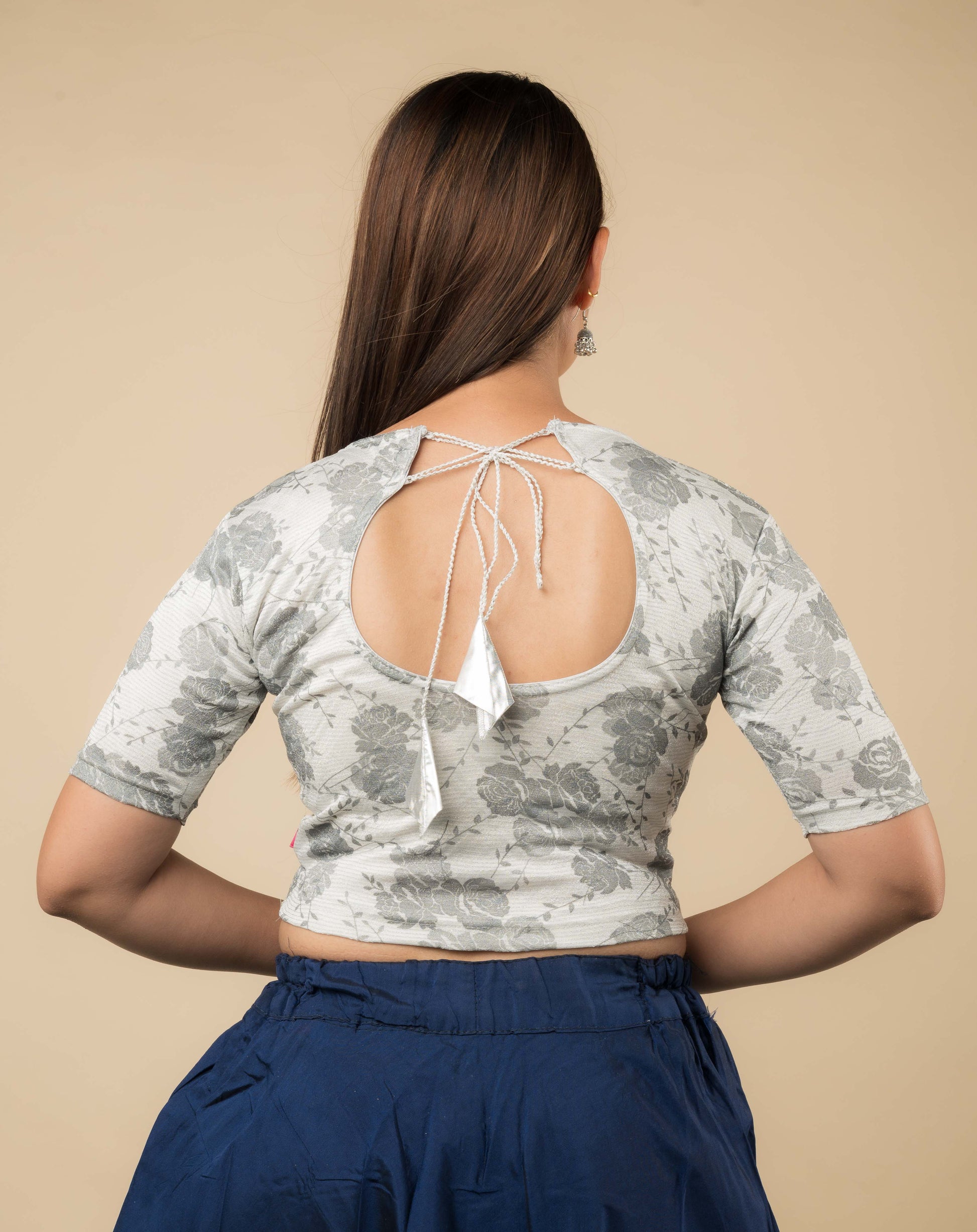 Rear view of the jacquard stretchable blouse showcasing the dori tie-up with tassels.