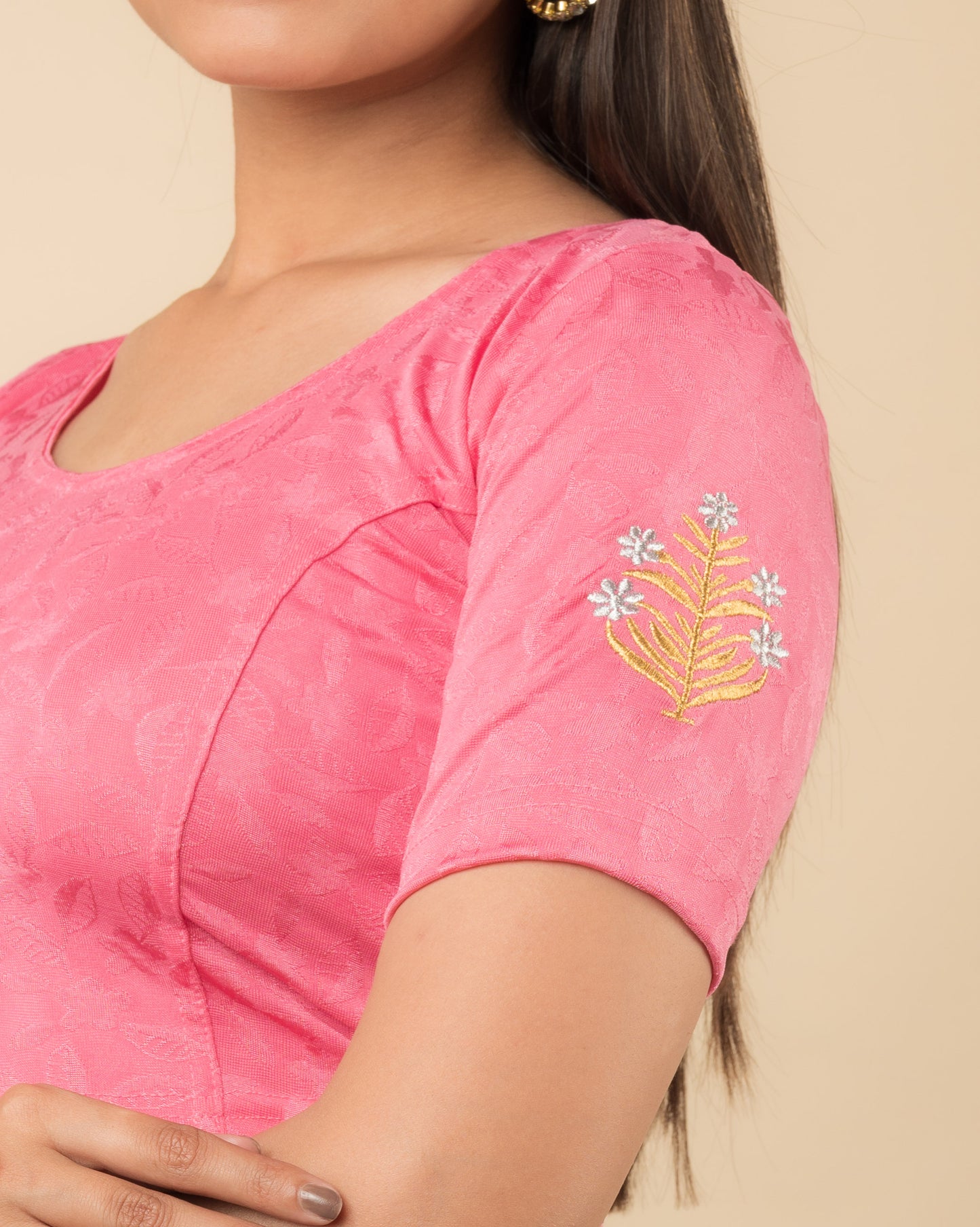 Close-up of the stretchable knit fabric detailing the buti embroidery of the readymade blouse.