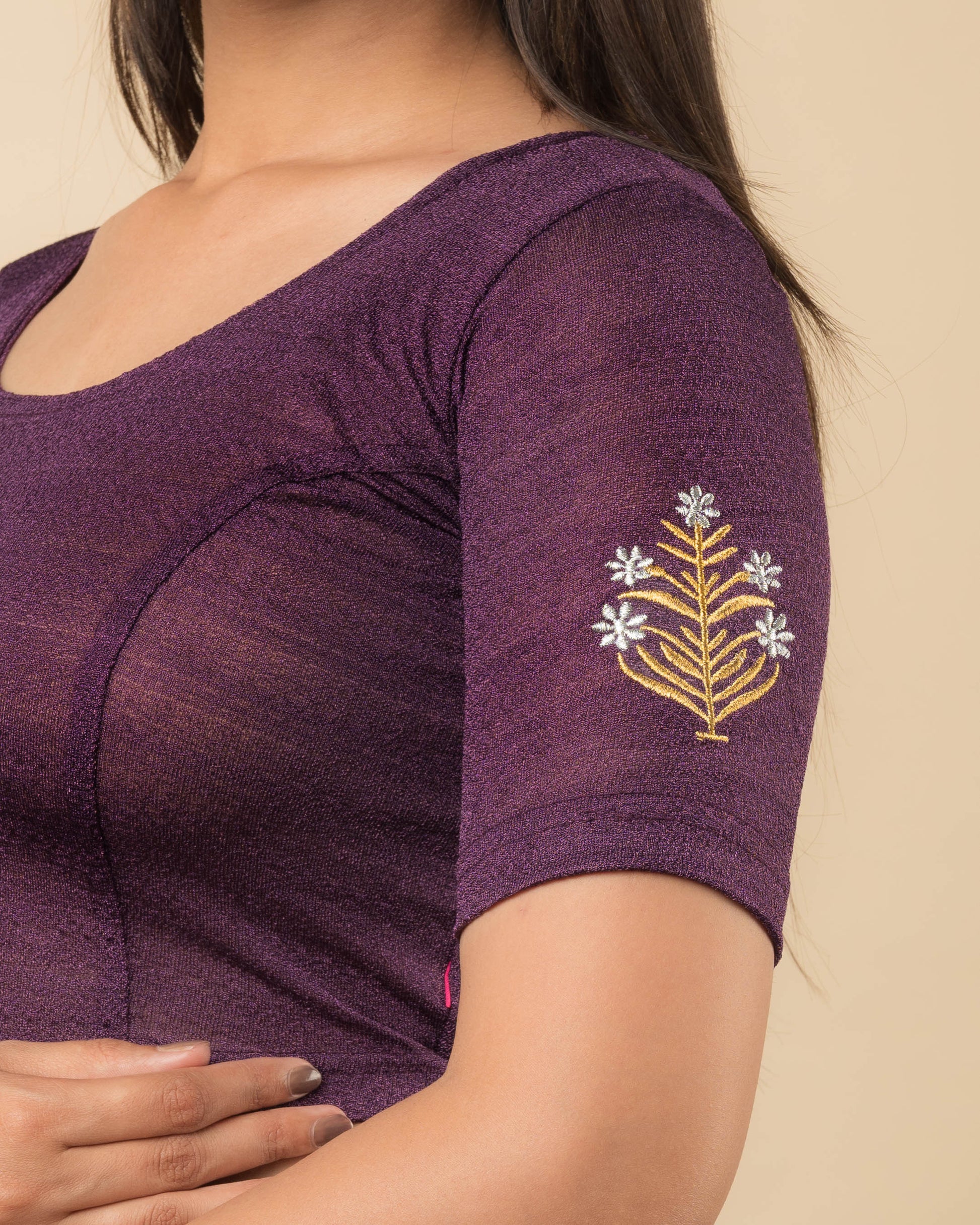 Close-up of the stretchable knit fabric detailing the buti embroidery of the readymade blouse.