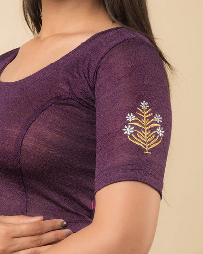 Close-up of the stretchable knit fabric detailing the buti embroidery of the readymade blouse.