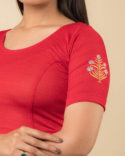  Close-up of the stretchable knit fabric detailing the buti embroidery of the readymade blouse.
