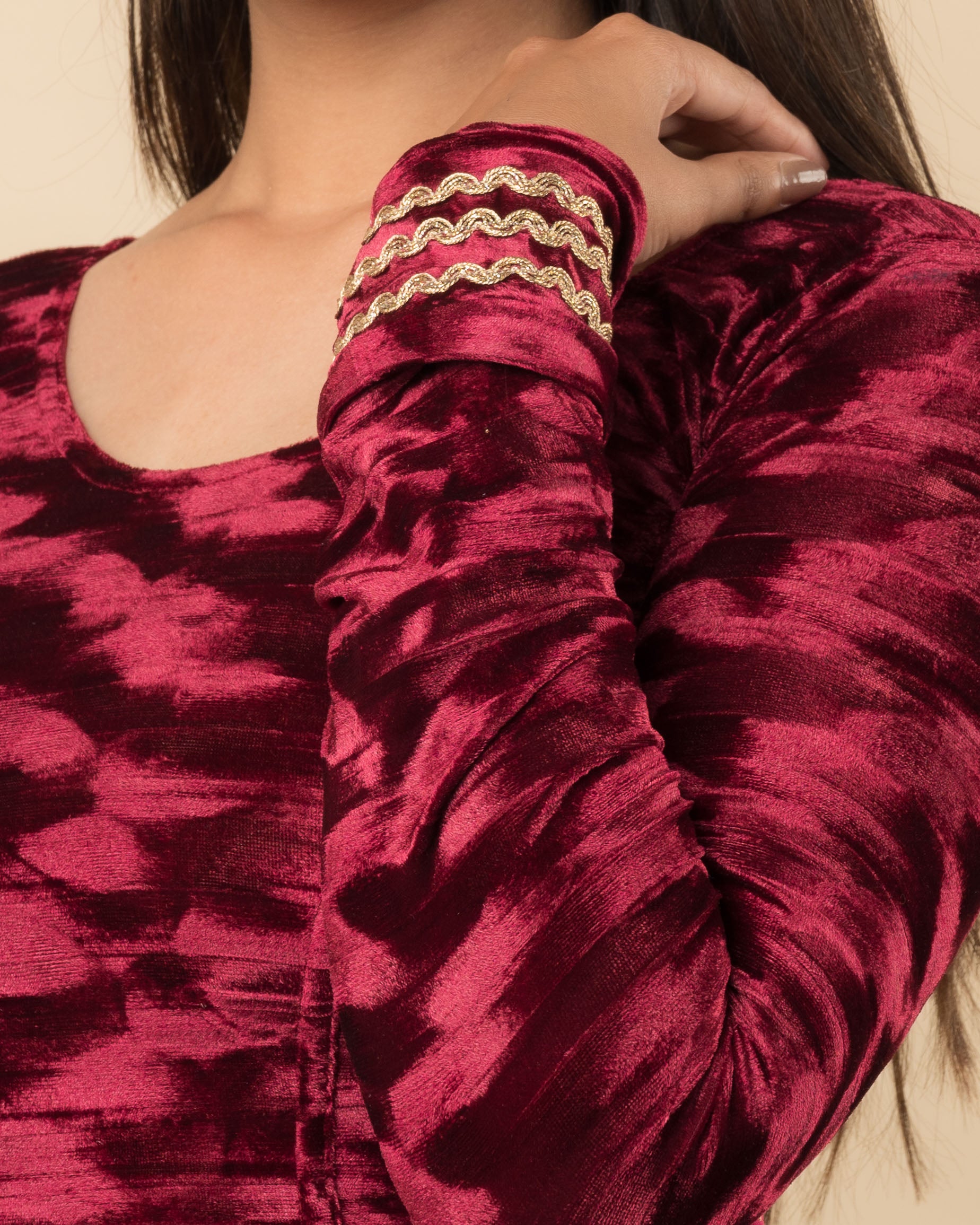 Close-up of the velvet fabric detailing the zari embroidery and stretchability of the readymade blouse.