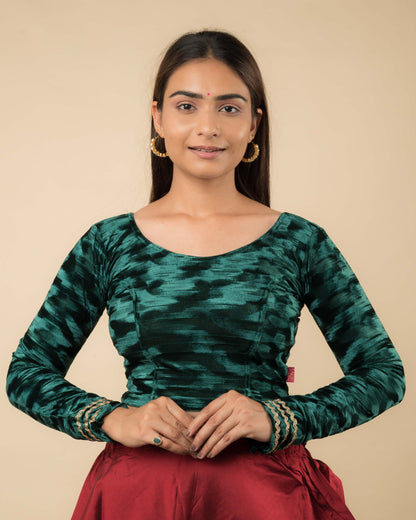 Model wearing a velvet stretchable readymade blouse with full sleeves and round neckline.