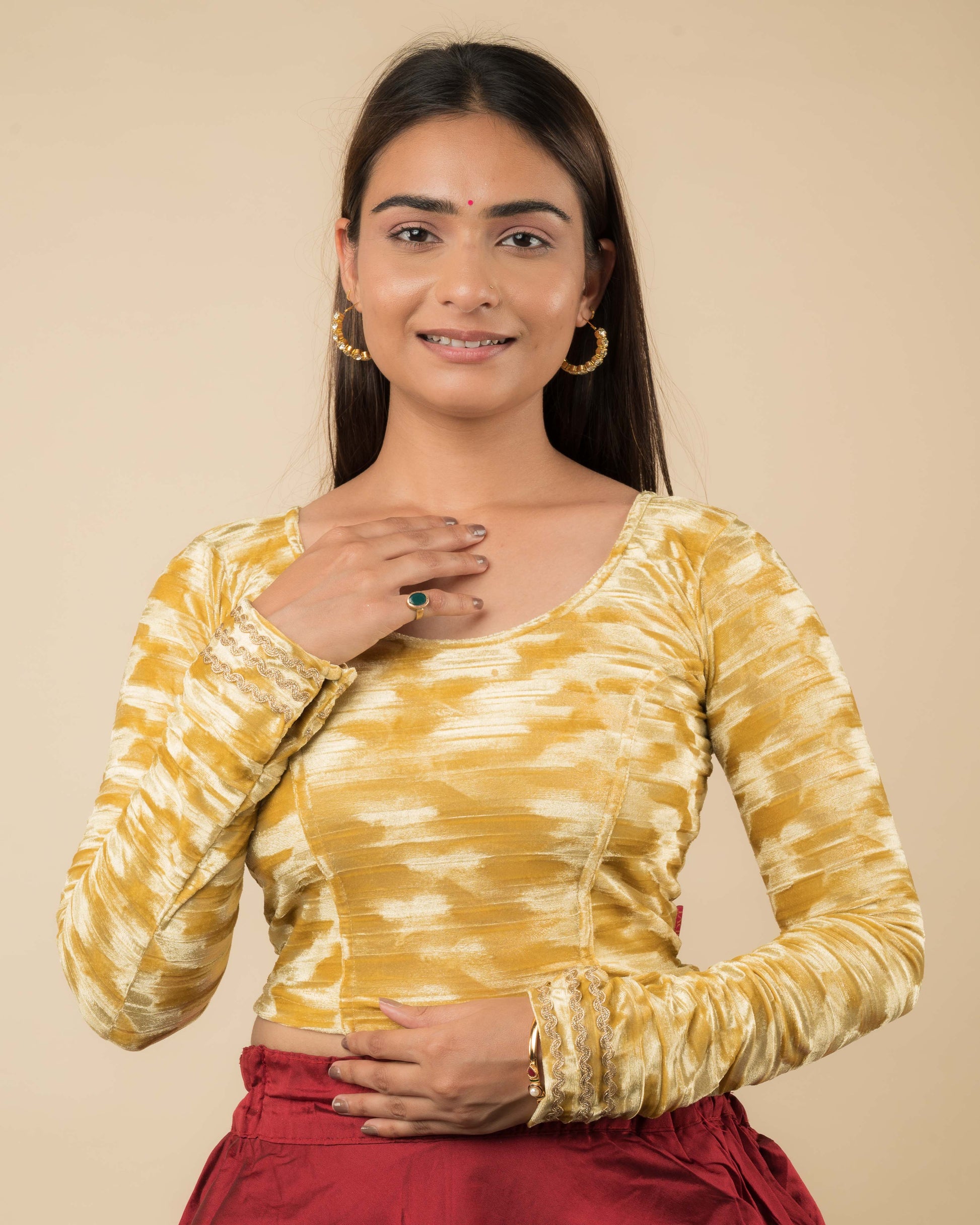 Model wearing a velvet stretchable readymade blouse with full sleeves and round neckline