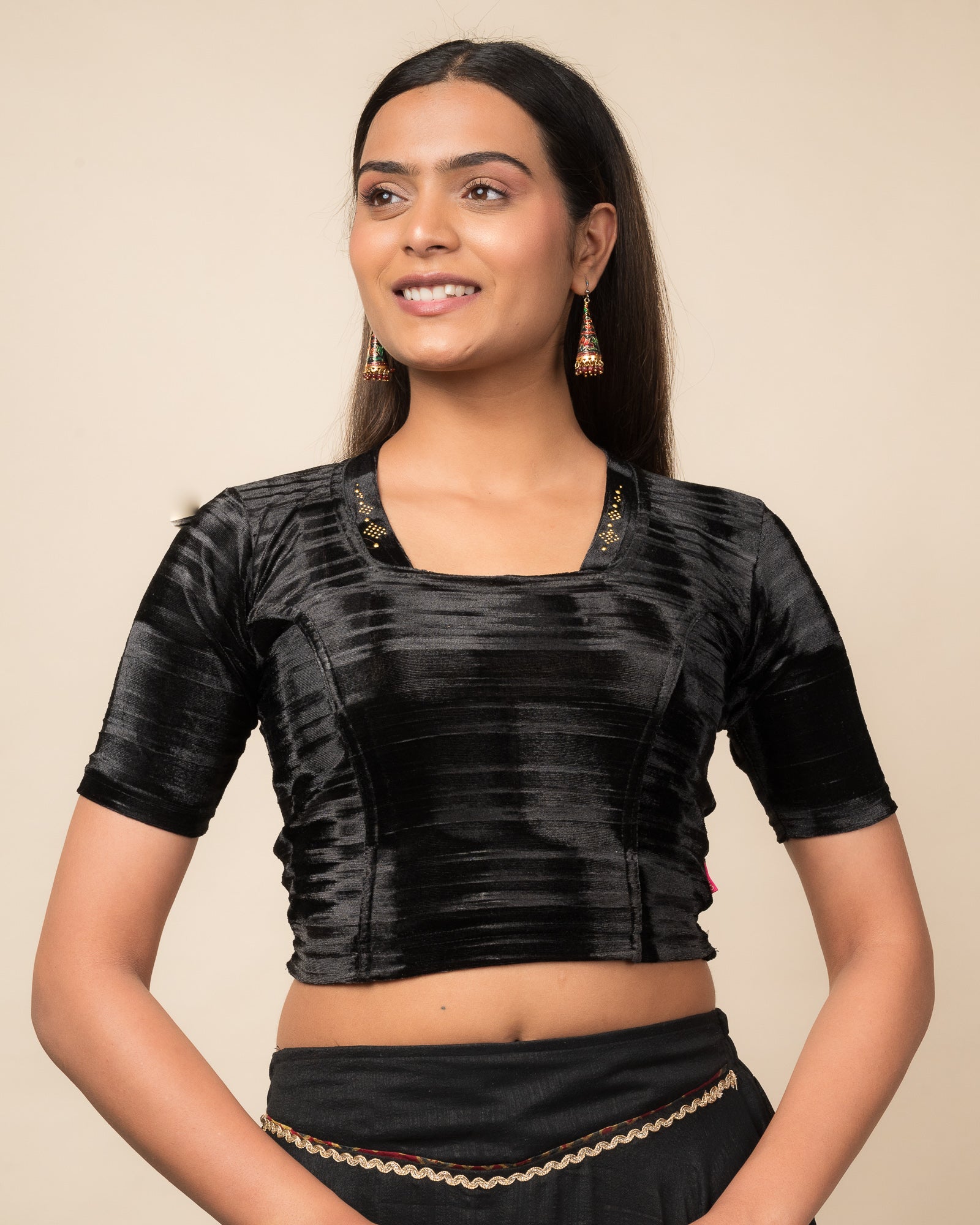 Model wearing a velvet stretchable readymade blouse with elbow sleeves and square neckline adorned with a diamond collar.