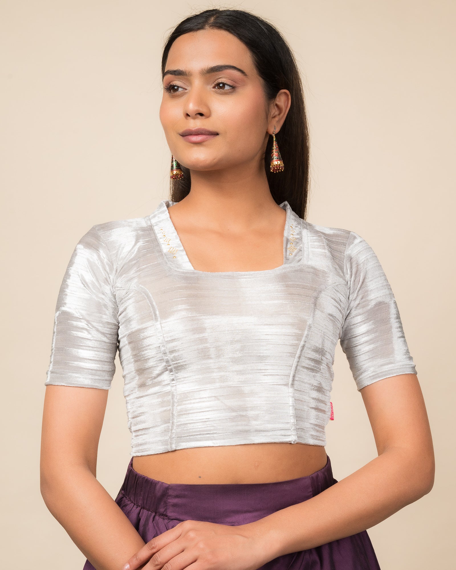 Model wearing a gray velvet stretchable readymade blouse with elbow sleeves and square neckline adorned with a diamond collar.