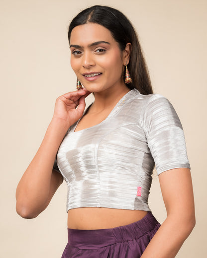 Side profile of the gray velvet stretchable blouse highlighting the fit and sleeve length.