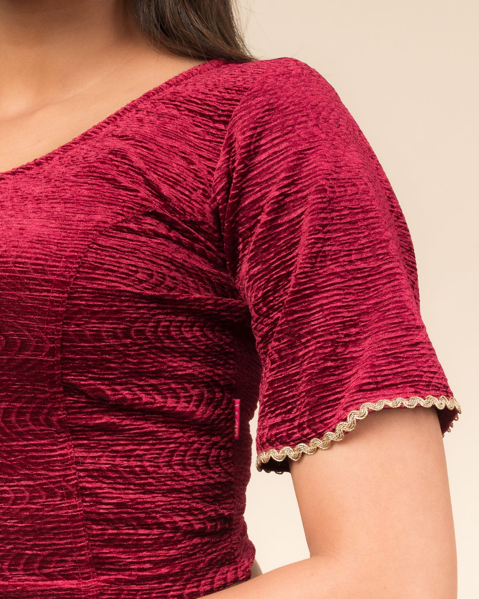 Close-up of the velvet fabric detailing the lace embroidery and stretchability of the readymade blouse.