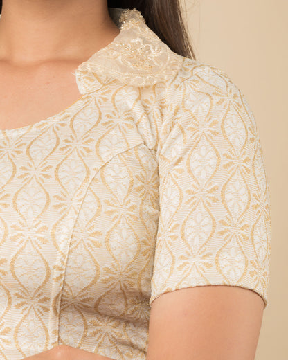 Close-up of jacquard fabric with detailed hand-beaded embroidery.