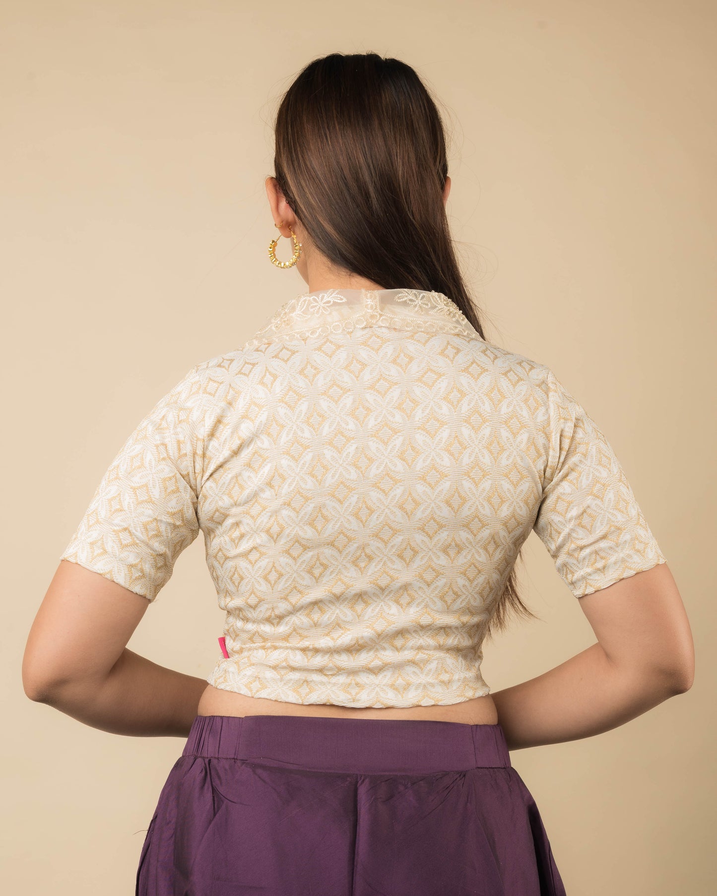 Rear view showcasing the collar’s embroidery and back design.