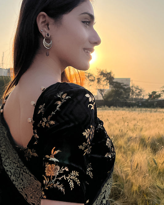  Model paired the blouse with a saree for a festive-ready ensemble.