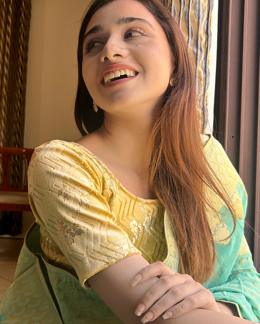 Model paired the blouse with a saree for a festive-ready ensemble.