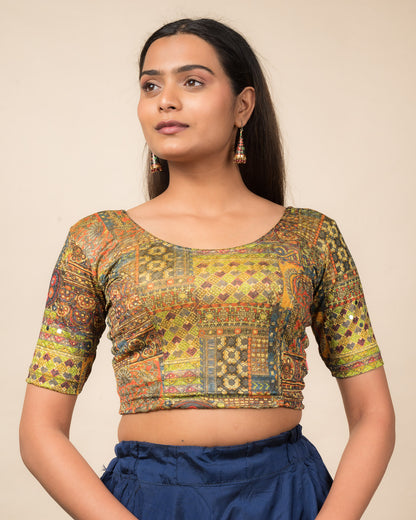 Model wearing a stretchable blouse with elbow sleeves and round neckline featuring ethnic mirror embellishments.