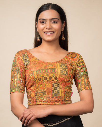 Model wearing a stretchable blouse with elbow sleeves and round neckline featuring ethnic mirror embellishments.