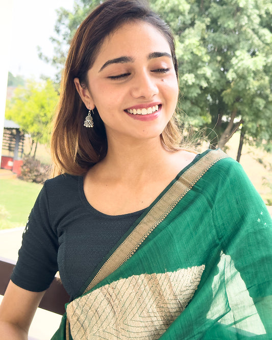 Model wearing a stretchable blouse with elbow-length sleeves and round neckline featuring mirror-embroidered butis.