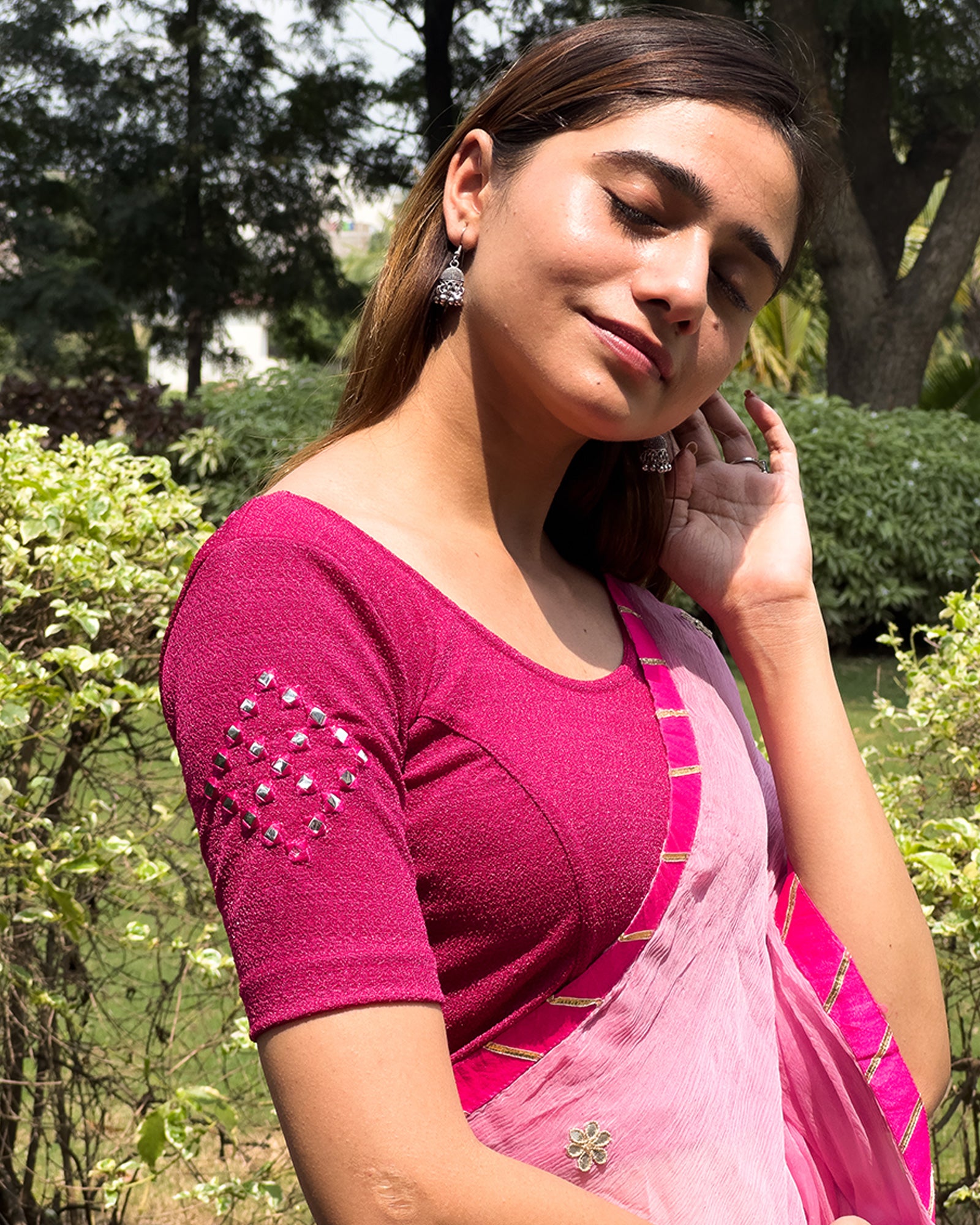 Model wearing a stretchable blouse with elbow-length sleeves and round neckline featuring mirror-embroidered butis