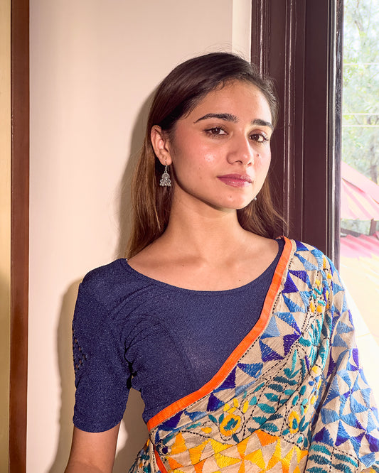Model wearing a stretchable blouse with elbow-length sleeves and round neckline featuring mirror-embroidered butis.