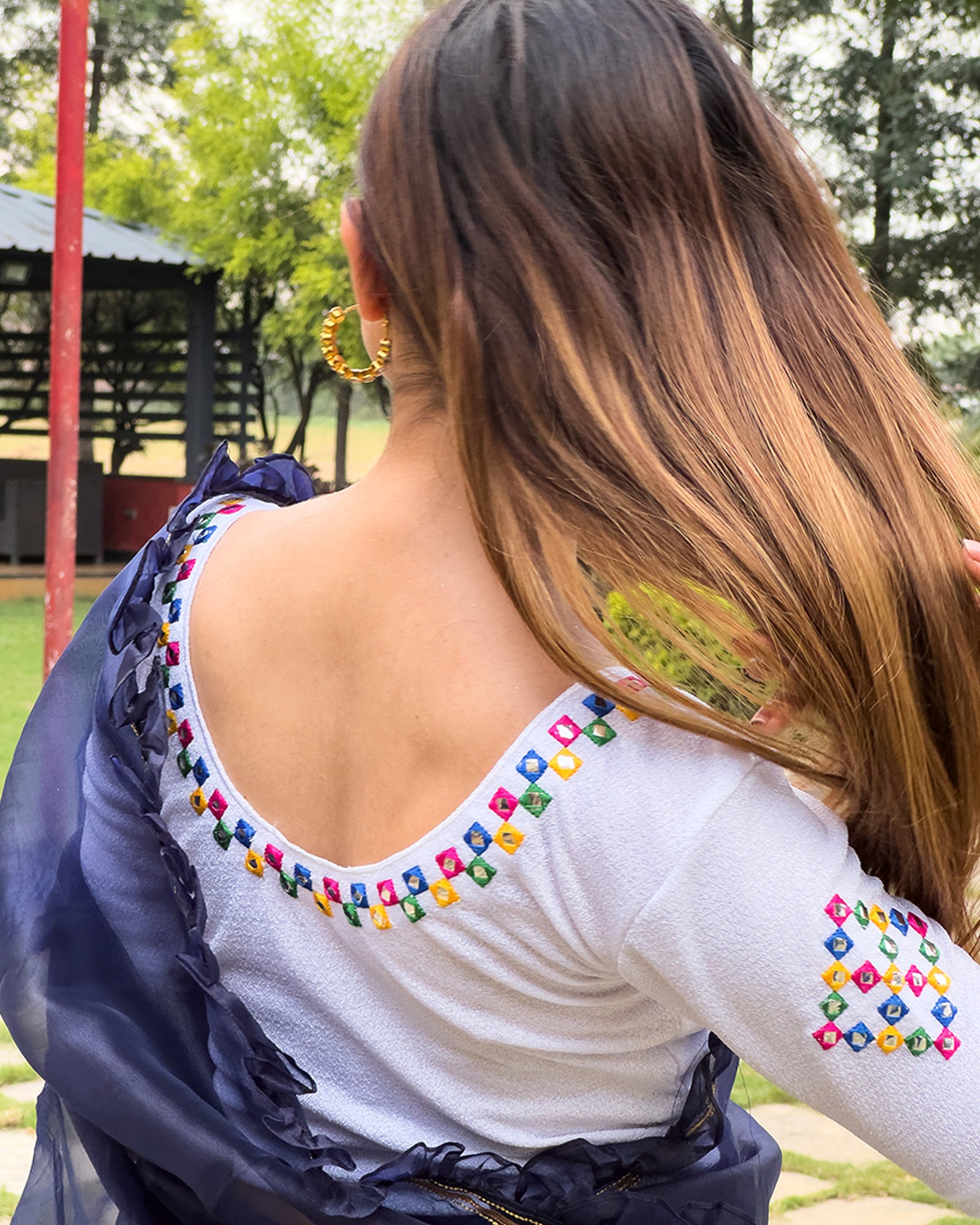 Rear view showcasing the embroidered details and back fit.