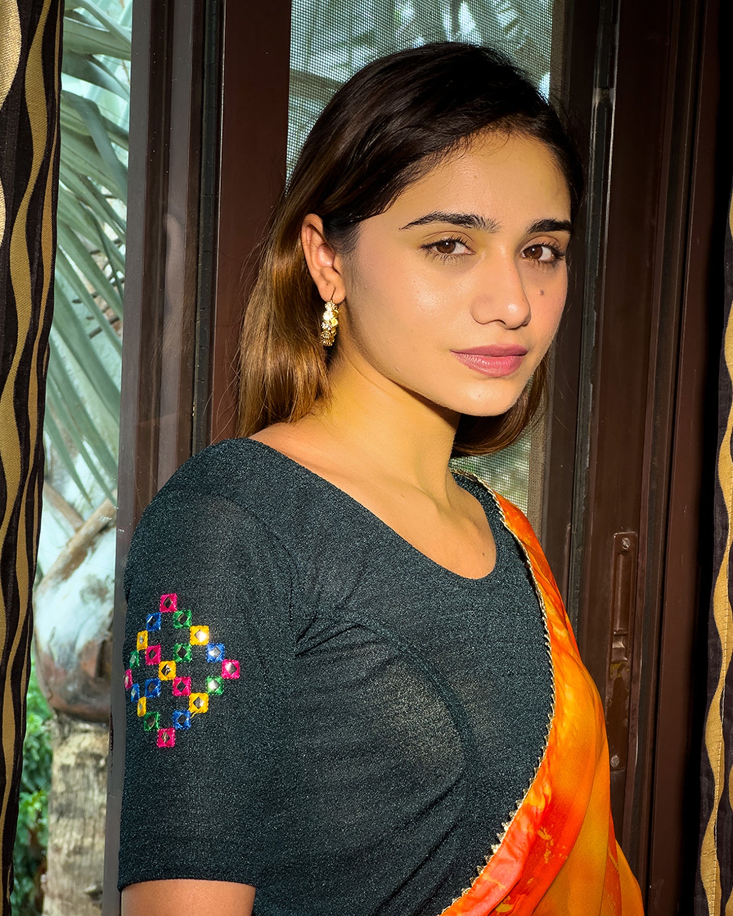Model pairing the blouse with a saree, styled for festive occasions.