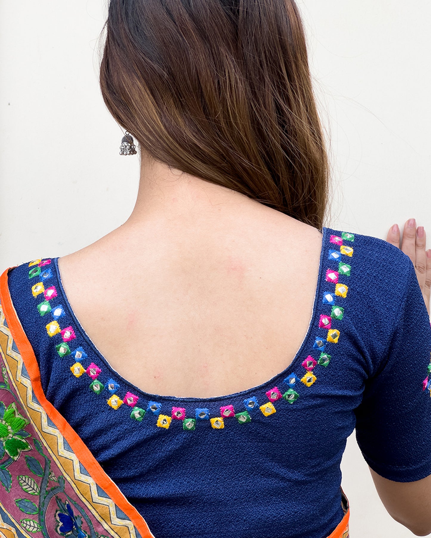 Rear view showcasing the embroidered details and back fit.