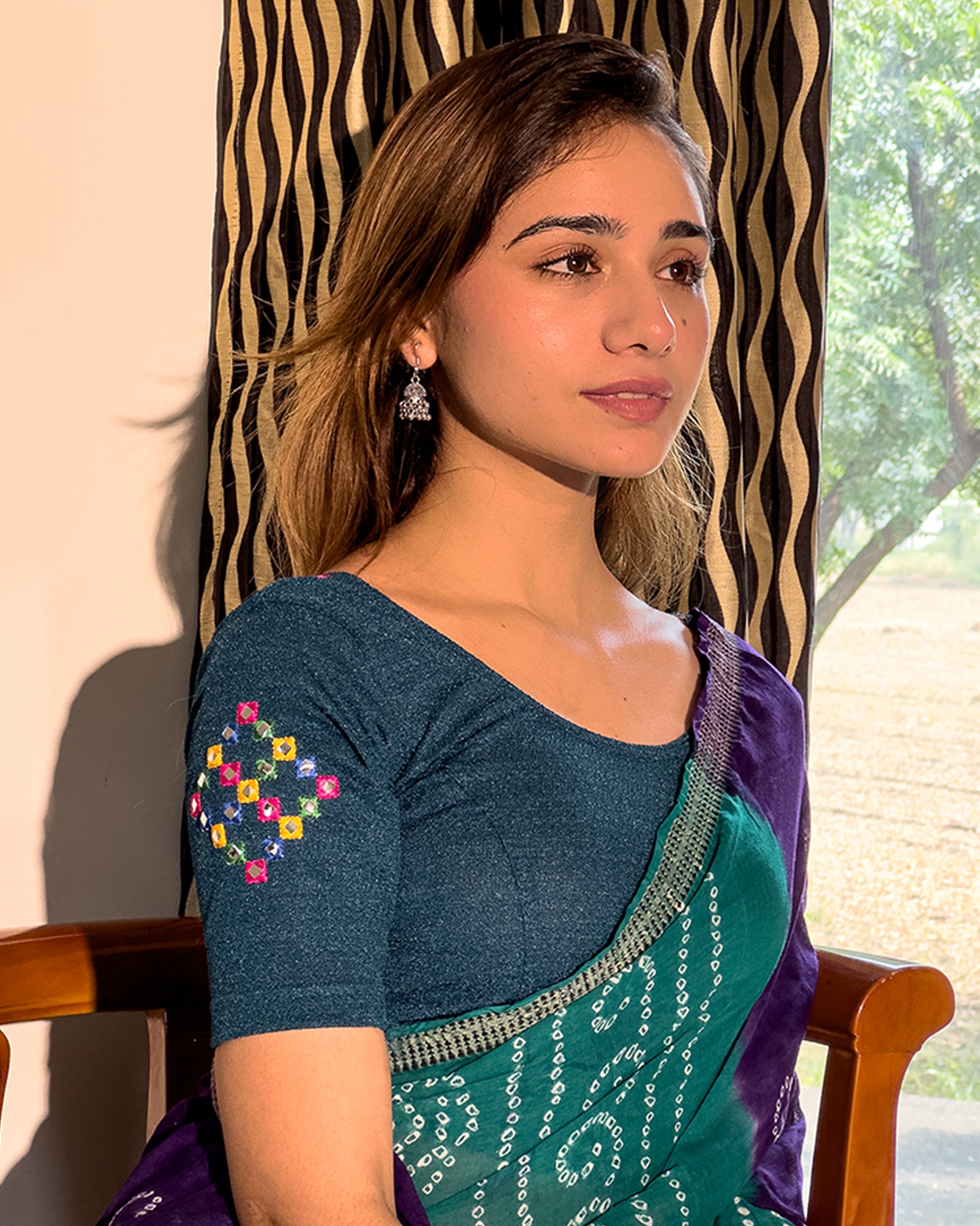 Model pairing the blouse with a saree, styled for festive occasions.