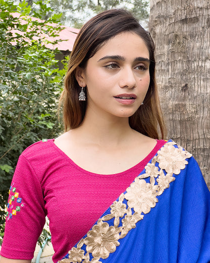 Model wearing a stretchable blouse with mirror embroidery on the neckline and sleeves.