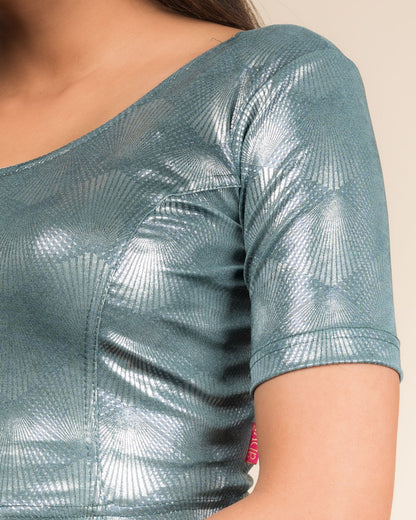 Close-up of the jacquard knit fabric with glittery metallic detailing.
