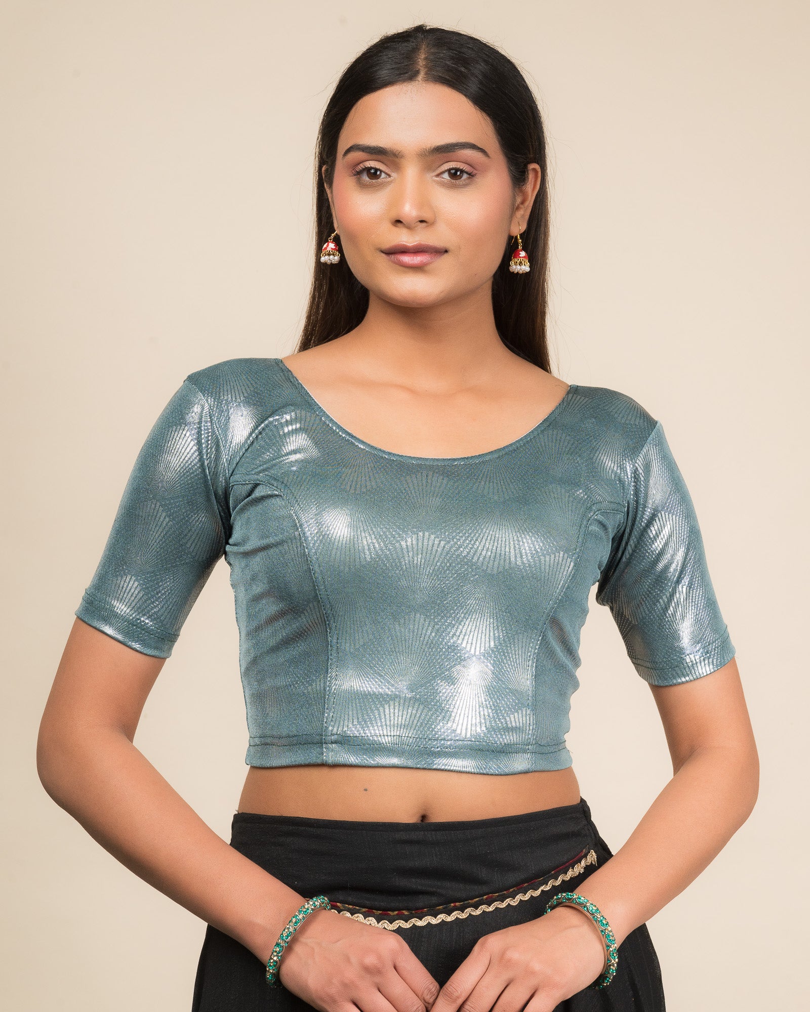 Model wearing a stretchable slip-on blouse with round neckline and elbow sleeves, showcasing a sleek metallic finish.